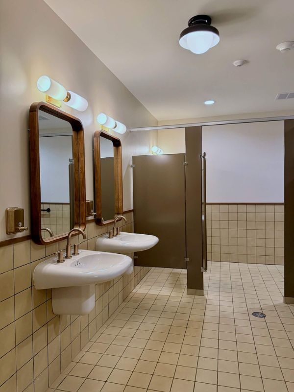 Renovated restroom with vintage style tile flooring and wall tile at Church of Pickleball commercial project in Chicago Illinois