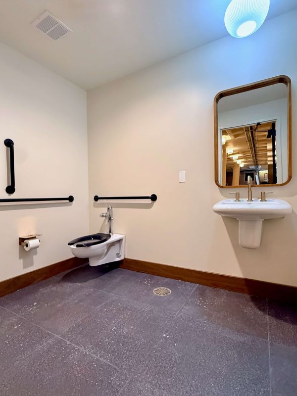 Accessible restroom with commercial tile flooring installed during Church of Pickleball renovation project in Chicago IL