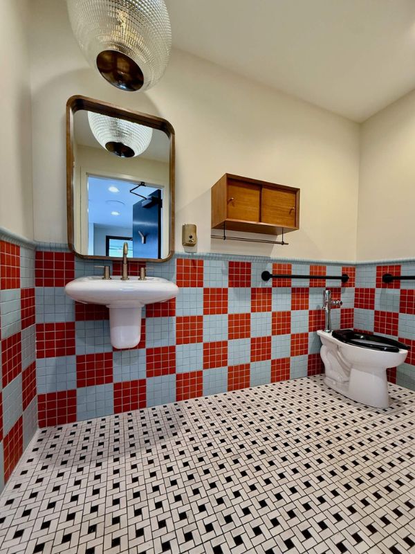 Red and white retro tile restroom flooring installed during Church of Pickleball commercial renovation in Chicago Illinois