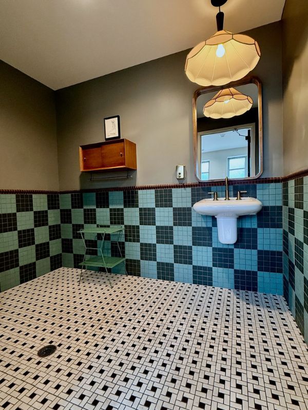 Green and blue vintage wall tile with mosaic tile flooring in Church of Pickleball restroom renovation in Chicago IL